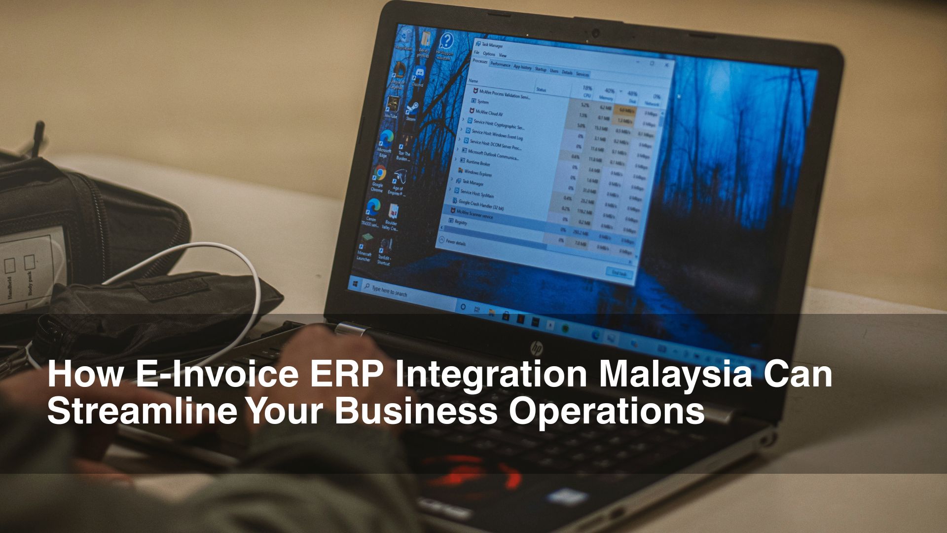 Man types on dark laptop for e-invoicing