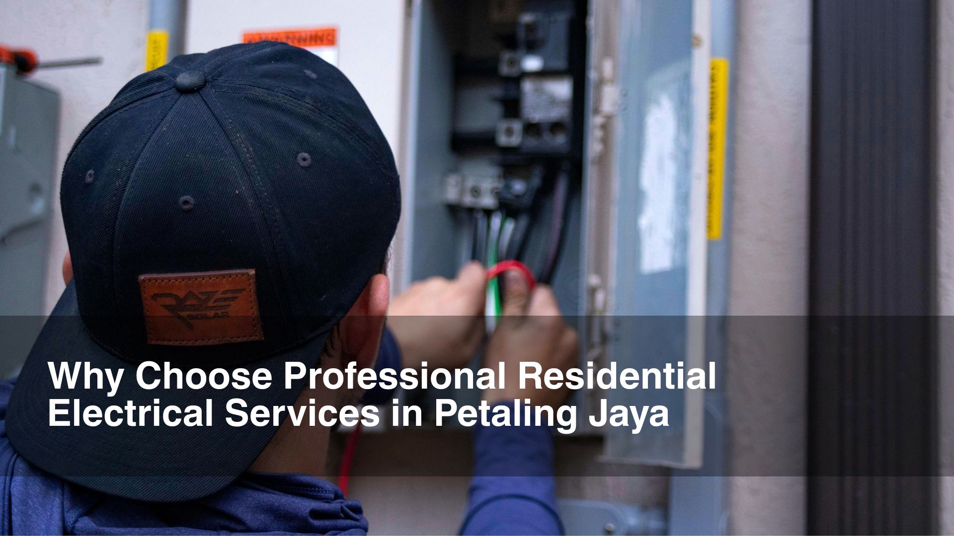 man in black works on residential electrical services